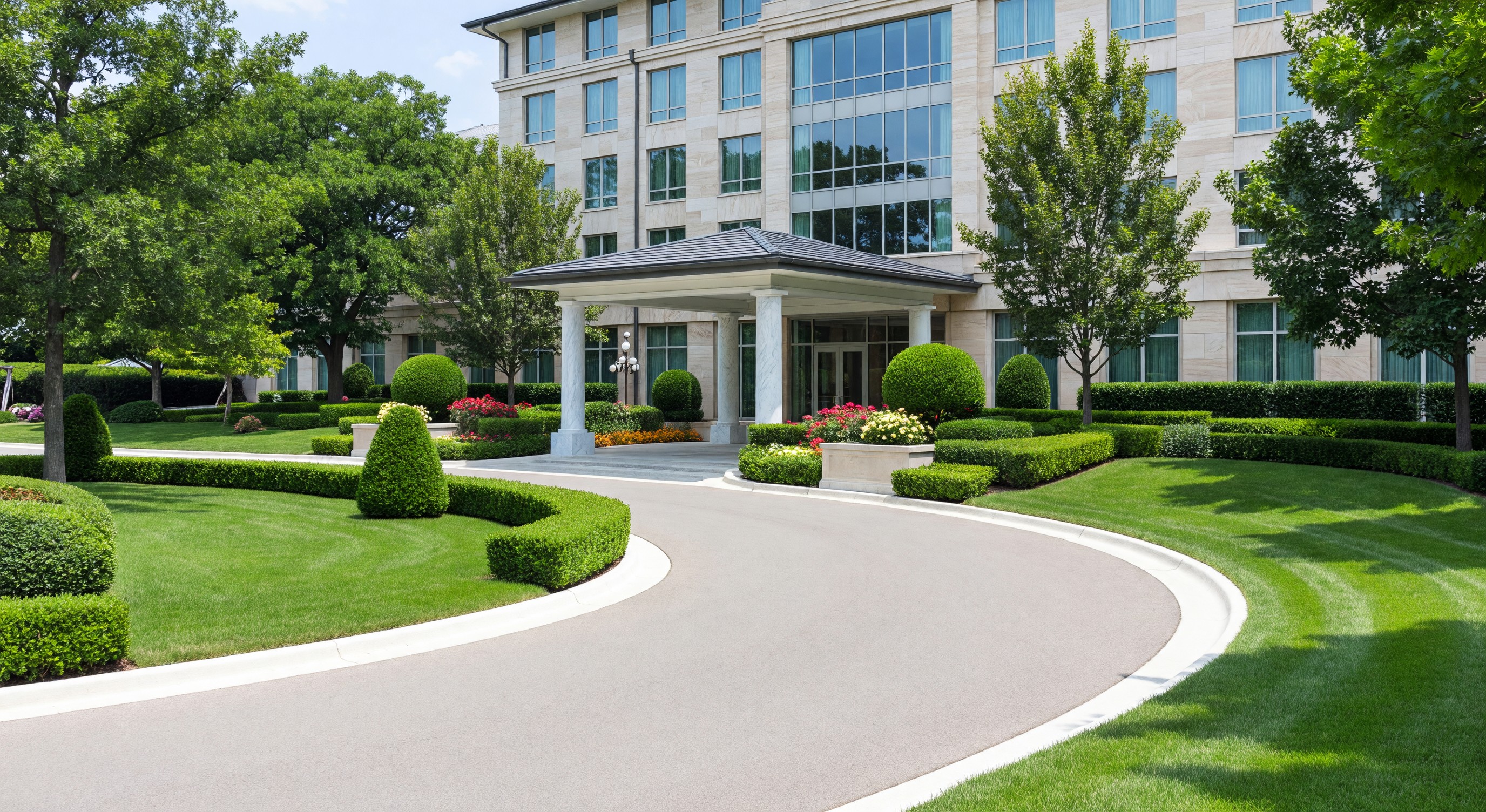 Well-maintained hotel grounds with manicured landscaping and entrance driveway
