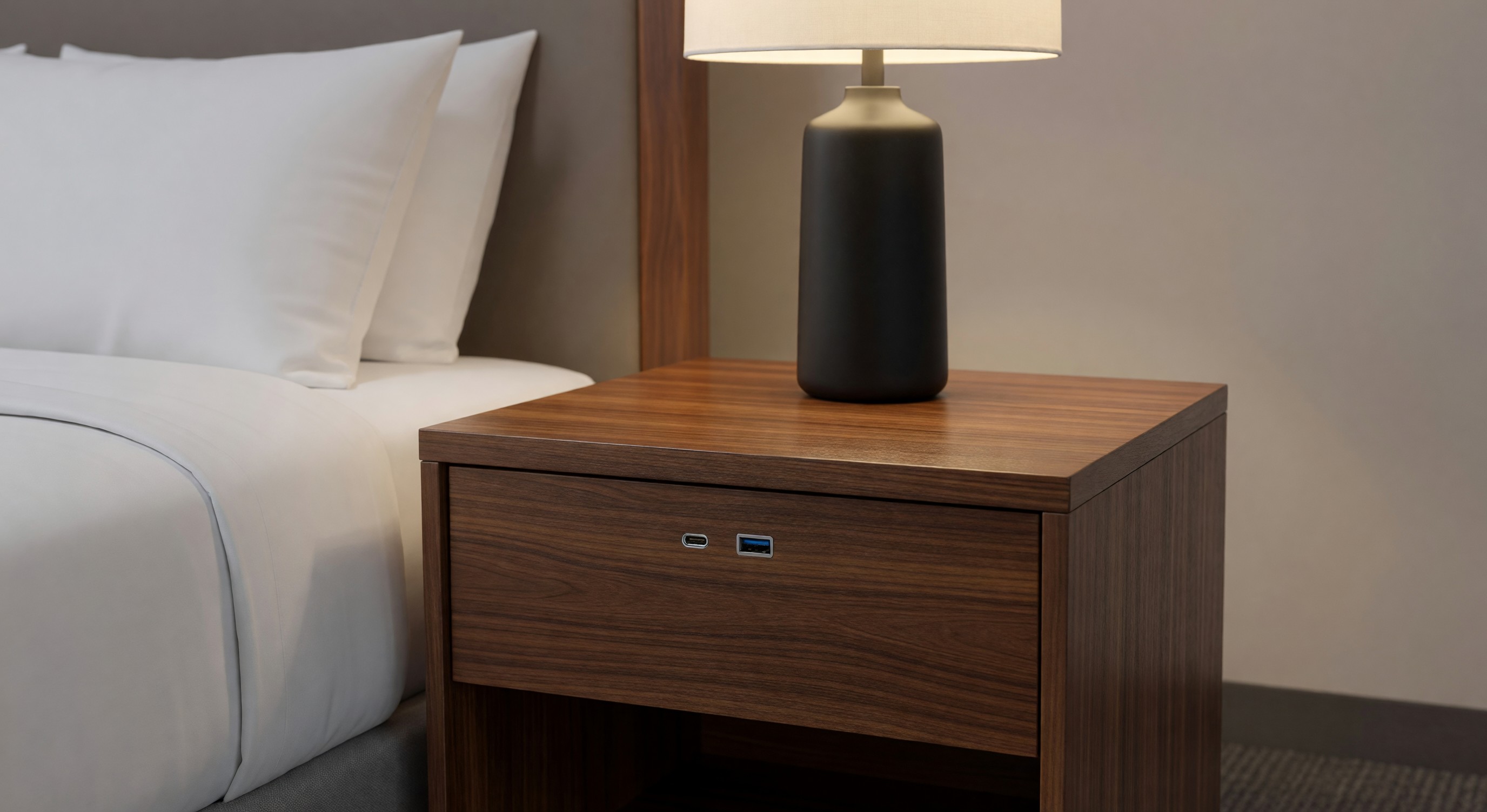 Hotel nightstand with USB-C and USB-A charging ports integrated into bedside unit