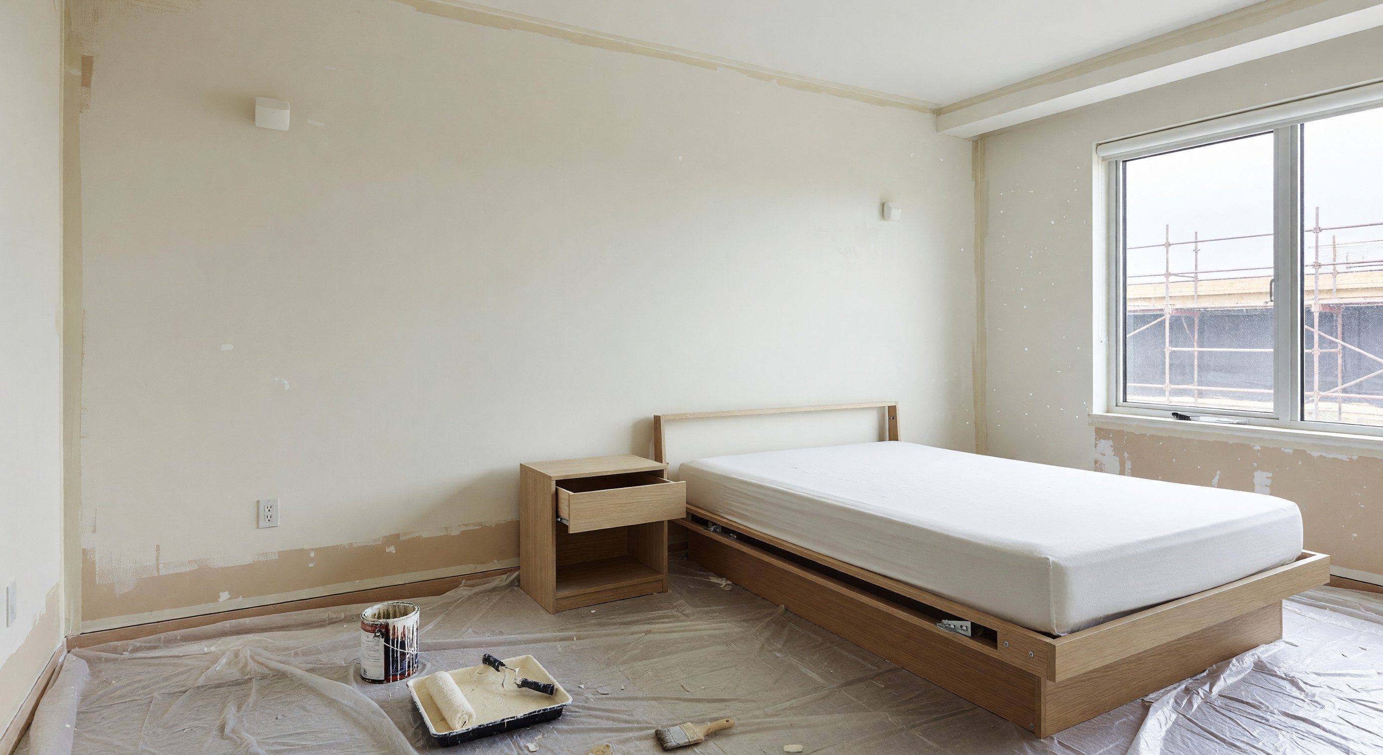 Hotel guest room during renovation showing fresh paint and updated furnishings in progress