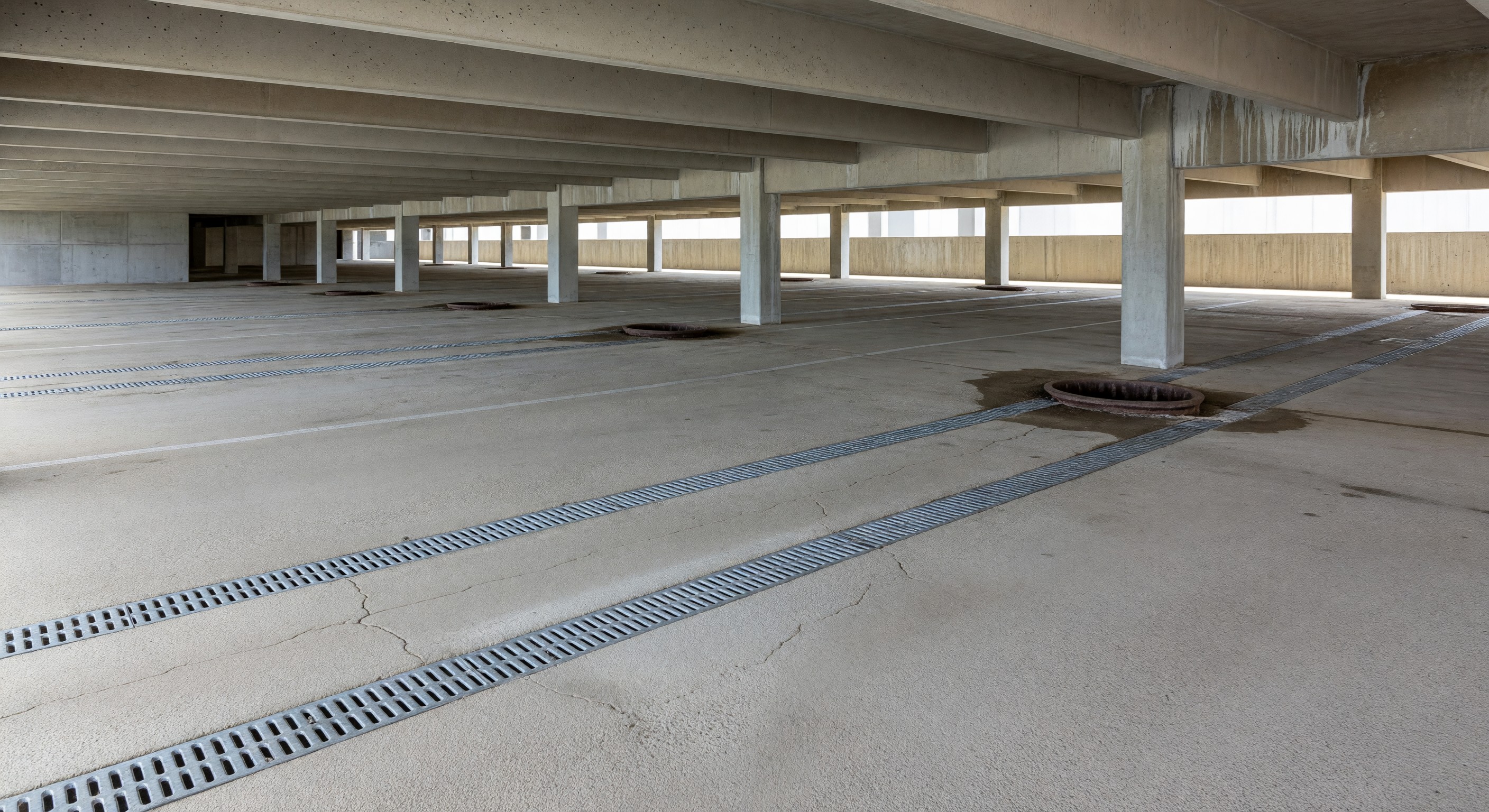 Hotel parking structure showing concrete deck and drainage systems